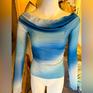 Women’s shade of sheer blues, loose fold over neckline on or just off shoulder.